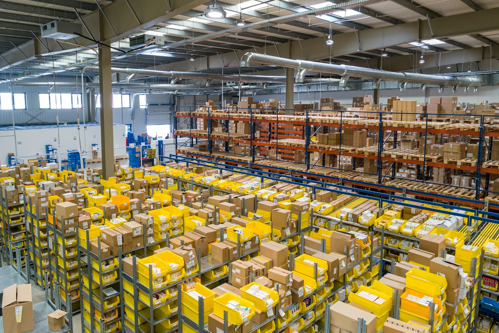 Aerial view of an organized fulfillment warehouse floor with rows of sorted shipping totes.